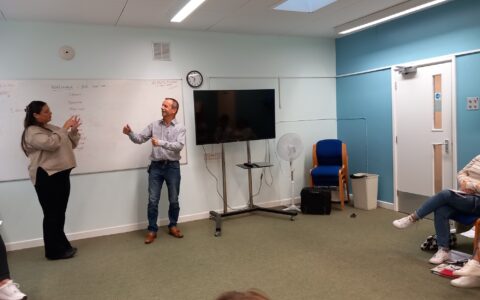 Saydi and BSL tutor showcasing their British Sign Language conversation to the class