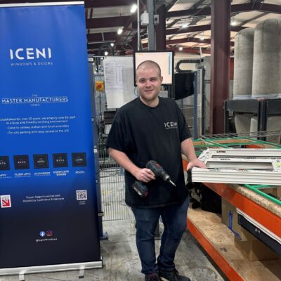 A photo of Callum working as a window fabricator