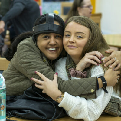 Customer and staff hugging