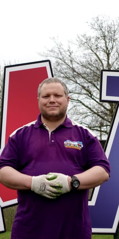 Young man with a learning disability working at a farm park, Marsh Farm.