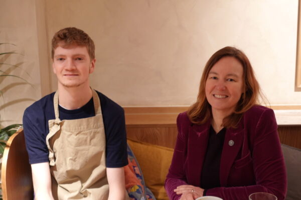 A young man, Michael, sitting next to Marie Goldman, Colchester MP