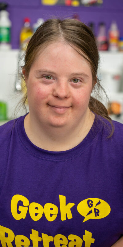 Young lady with downs syndrome working at gaming cafe, Geek Retreat.