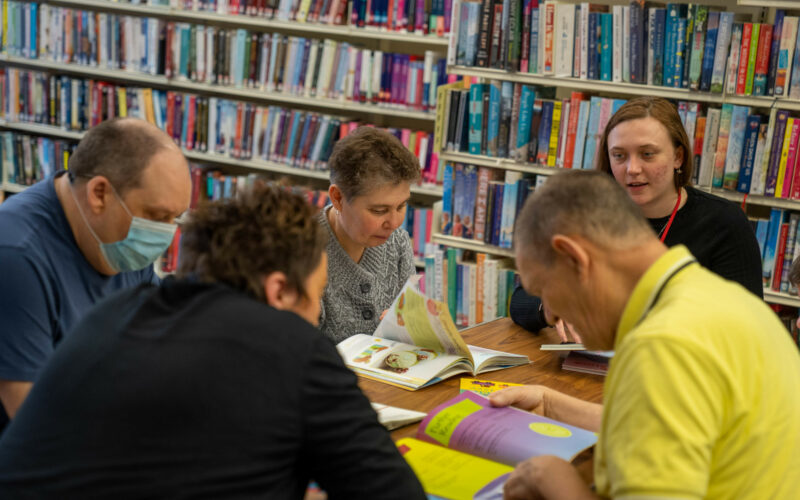 A group of people sat reading
