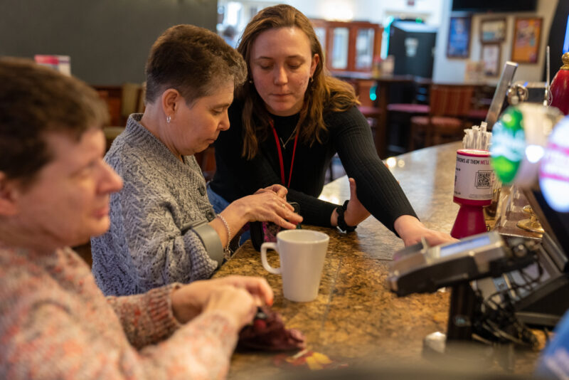 Carer helping out women