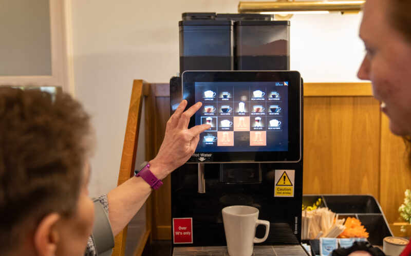 Carer helping women to choose a drink