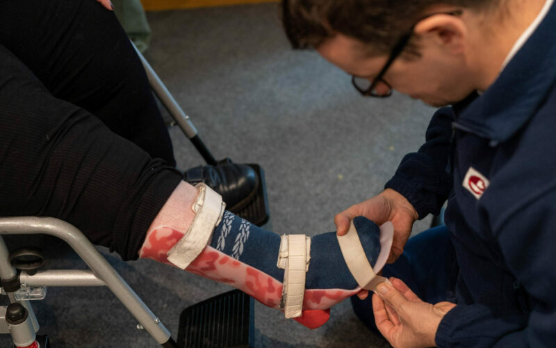 Carer helping patient