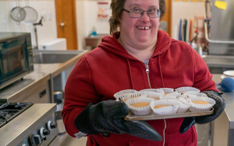 Smiling customer holding cupcakes