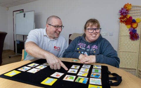 A positive behaviour support advisor doing a Talking Mat with a person with learning disabilities and autism