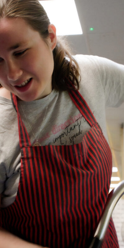 A young lady with a learning disability working at Perryfields infant school as a cleaner.