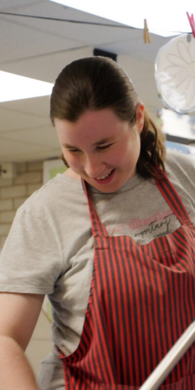 Young lady with learning disabilities working as a cleaner at Perryfields Infant School