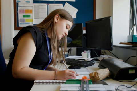 A young lady with autism working as an admin assistant in the school office