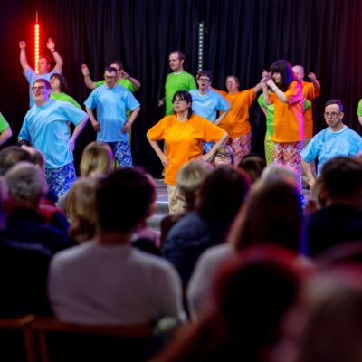 ECL's Crafty Drama Group performing on a stage in front of an audience.