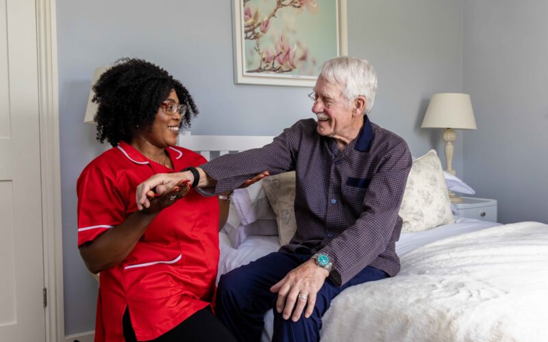 ECL customer and Community Care Assistant doing exercises