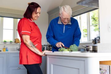 ECL customer and Community Care Assistant making food