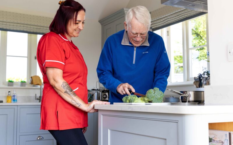 ECL customer and Community Care Assistant making food