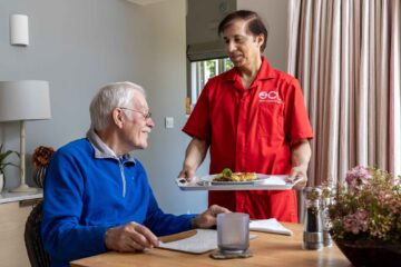 ECL customer and Community Care Assistant preparing dinner