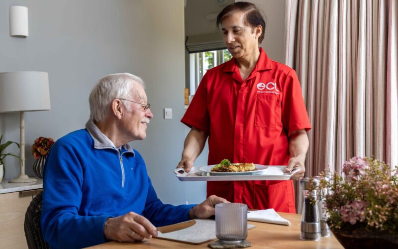 ECL customer and Community Care Assistant preparing dinner