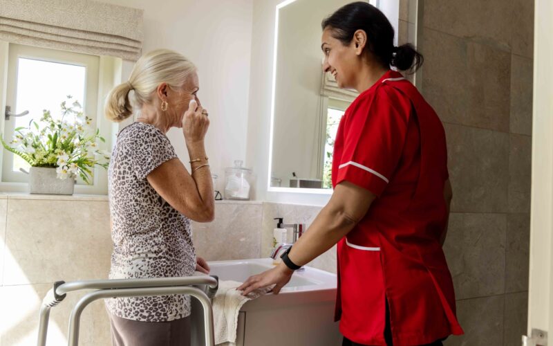 ECL customer and Community Care Assistant getting ready for bed