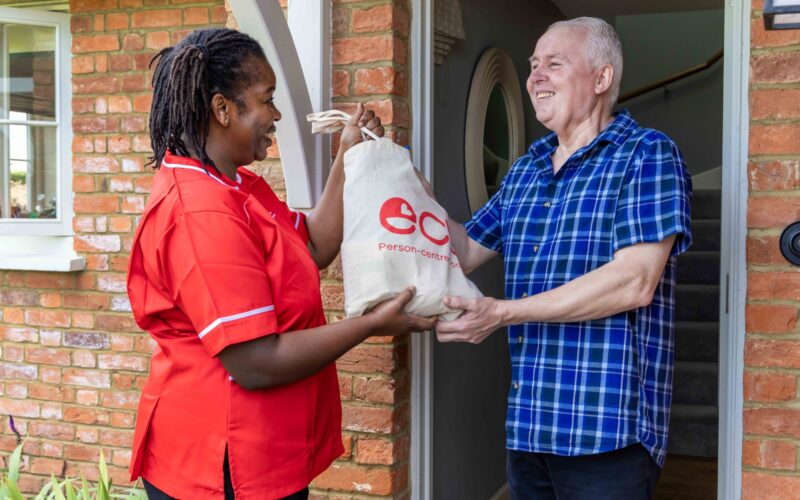 ECL customer and Community Care Assistant taking in food shopping