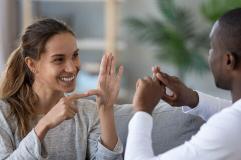 Carer helping a person who has hearing loss.