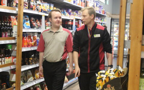 ECL customer James walking and talking with one of the Coop managers