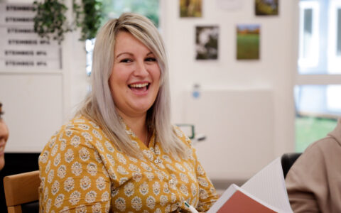 Jess Shorey laughing during a team meeting