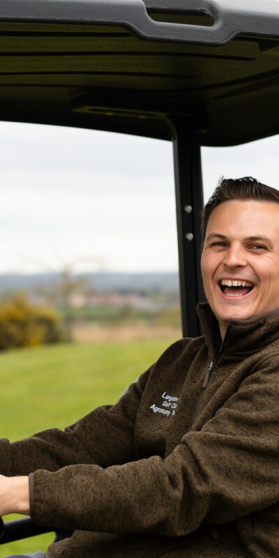 A man sitting in a vehicle.
