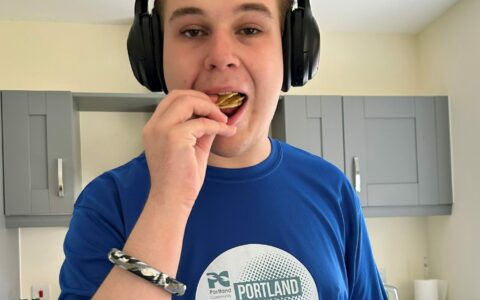 A young boy eating a biscuit.