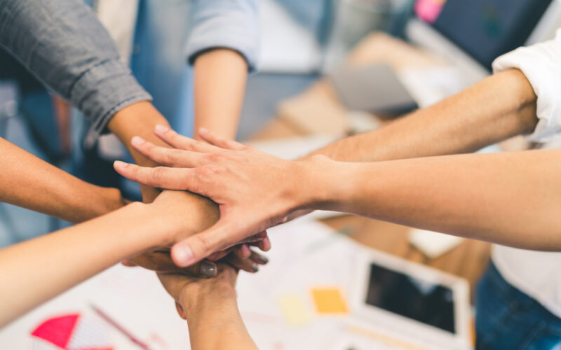 People with hands in a pile