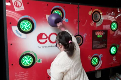 A woman using the cardio wall