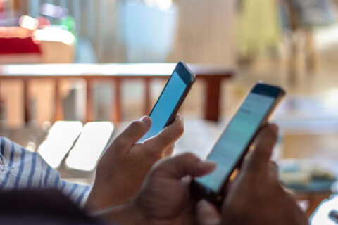 Two people using smartphones