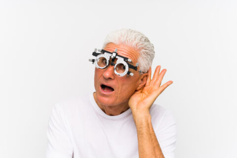 Man with hand cupping ear