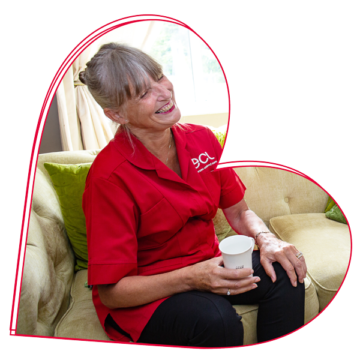 Older lady being guided outside of her house and into her back garden by an ECL Community Care Assistant.