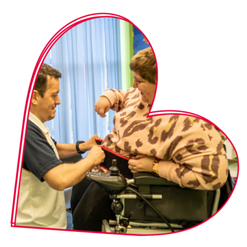 A woman in a wheelchair talking to a man