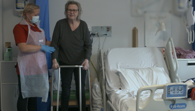 ECL Community Care Assistant supporting a customer to get out of her hospital bed