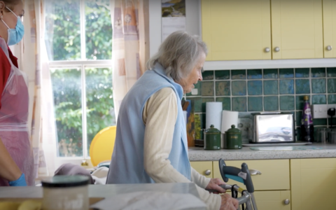 An elderly woman in a kitchen