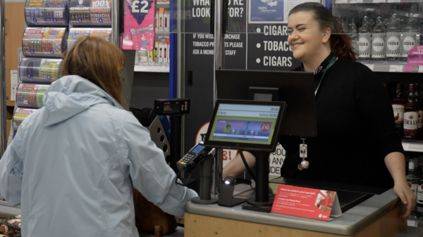 A young lady with a mild learning disability working at East of England Co-op