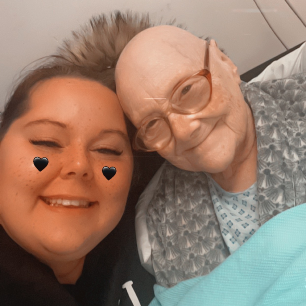 Two women hugging and smiling while looking at the camera