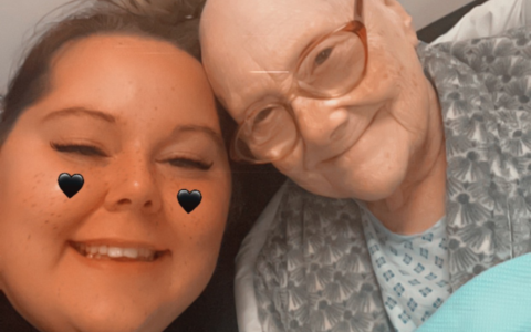 Two women hugging and smiling while looking at the camera